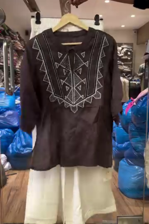 brown embroidered kurta with white wide-leg trousers.